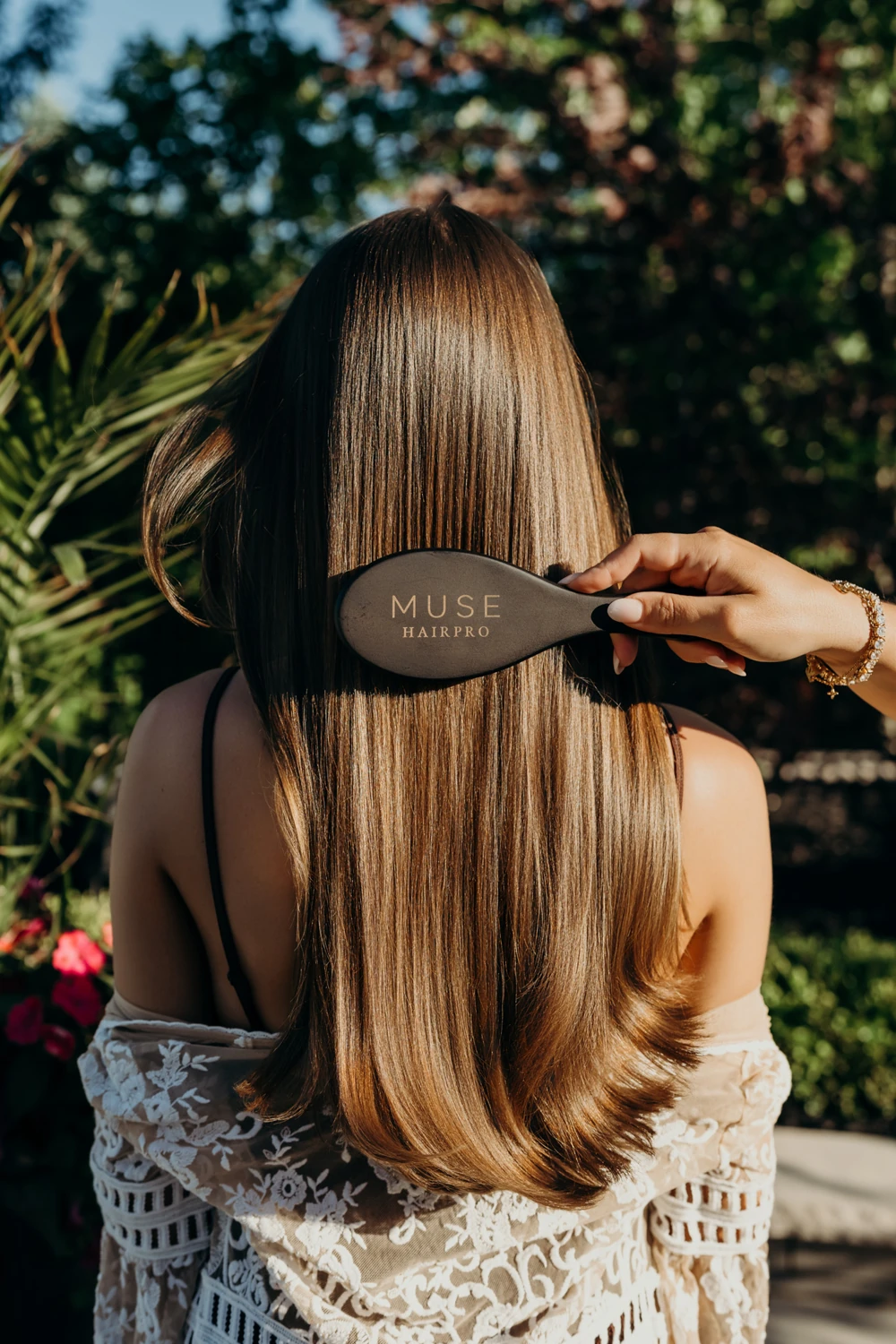 Long hair and a MUSE HAIRPRO brush in warm outdoor light